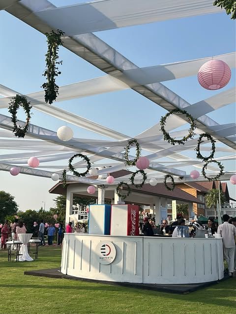The Kaffekos stall under a canopy of wreaths, ribbons and pink lanterns.