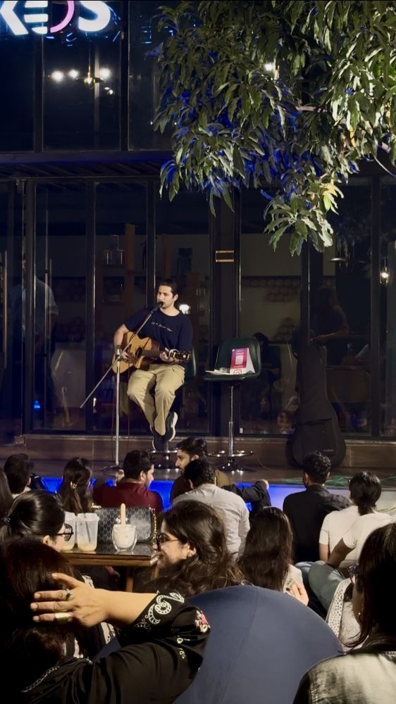Munis Mujahid on guitar, right in front of our glass house.